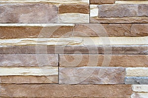 Brick wall with variegated brown bricks. Used as a background.