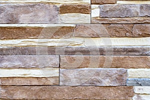 Brick wall with variegated brown bricks. Used as a background