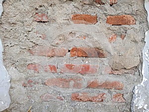 a brick wall that was exposed by plaster accidentally