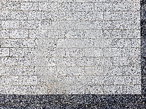 Brick wall in white and black. The texture of the tile facade is white and black. Brick wall in white and black