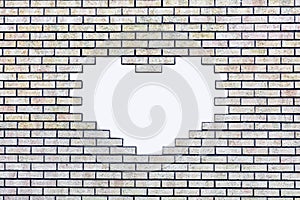 Brick wall with a white, heart-shaped hole for text photo