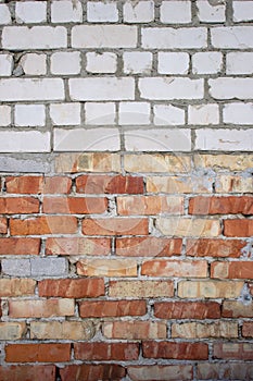 Brick wall of white and red bricks, texture and background, building houses