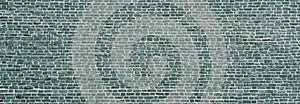 Brick wall, wide panorama of mint color masonry. Wall with small Bricks. Modern wallpaper design for web or graphic art projects.