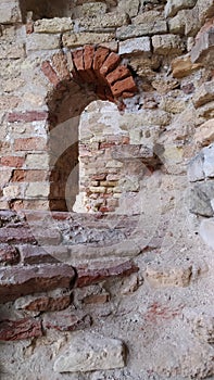 Brick wall and window to the white from stone