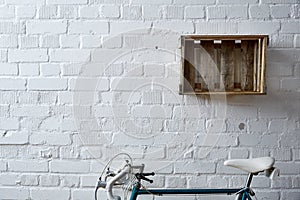 Brick wall with wine case and roadbike