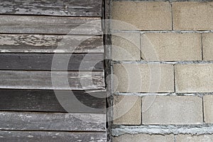 Brick wall and wooden wall divided in half for background