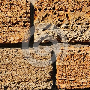 Brick wall of yellow shell rock. Background