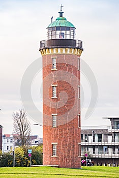 Bricked lighthouse with green roof on the coast of Cuxhaven, Germany