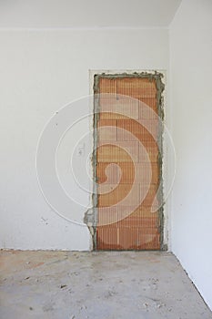bricked up door in a living room with white walls