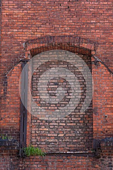 bricked up window in red brick building