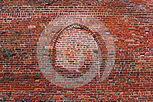Bricked window in red brick wall
