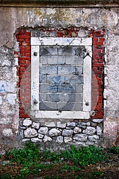 Bricked window in stone wall