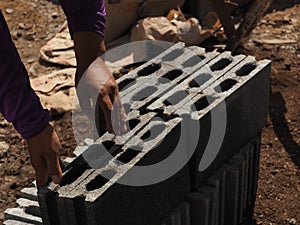 Bricklayer with brick at a construction site.