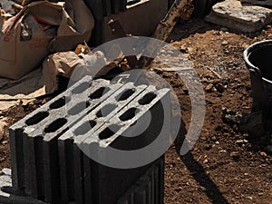 Bricklayer with brick at a construction site.