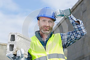 bricklayer builder working with autoclaved aerated concrete blocks walling