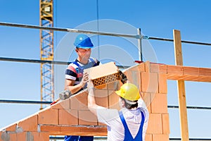 Bricklayer or builders on construction site working