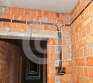 Bricklayer building new house with brick walls, interior rooms,wiring