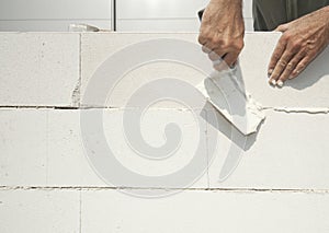 Bricklayer builds the wall