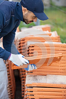 bricklayer industrial worker installing brick masonry