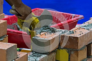 Bricklayer installing bricks, Bricklayer worker installing brick