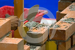 Bricklayer installing bricks, Bricklayer worker installing brick