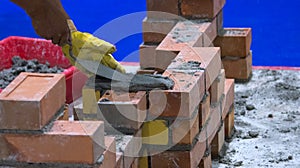 Bricklayer installing bricks, Bricklayer worker installing brick