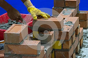 Bricklayer installing bricks, Bricklayer worker installing brick