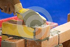 Bricklayer installing bricks, Bricklayer worker installing brick