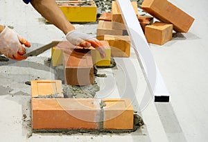 Bricklayer installing bricks, Bricklayer worker installing brick