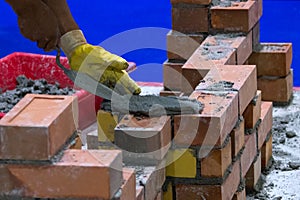 Bricklayer installing bricks, Bricklayer worker installing brick