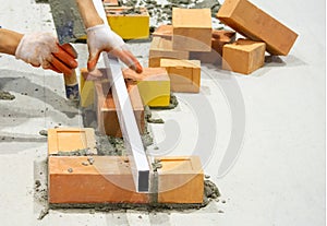Bricklayer installing bricks, Bricklayer worker installing brick