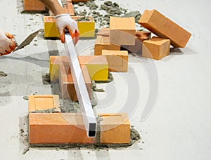 Bricklayer installing bricks, Bricklayer worker installing brick