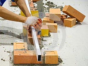 Bricklayer installing bricks, Bricklayer worker installing brick