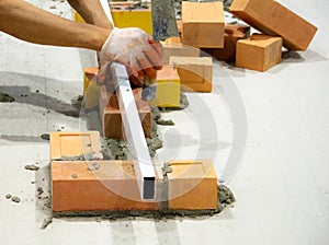 Bricklayer installing bricks, Bricklayer worker installing brick