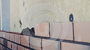 bricklayer lays bricks, exterior wall