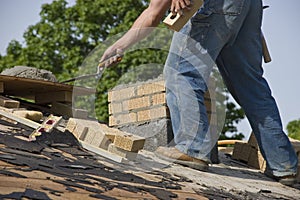 Bricklayer Mason Laying Chimney Bricks on House