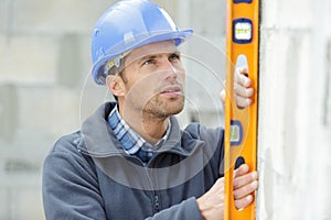 bricklayer putting down another row bricks in site
