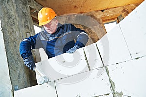 Bricklayer at work with silicate brick