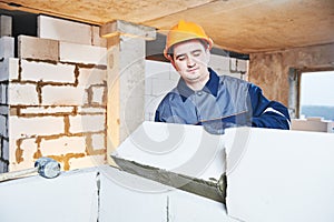 Bricklayer at work with silicate brick