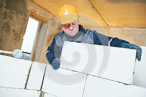 Bricklayer at work with silicate brick