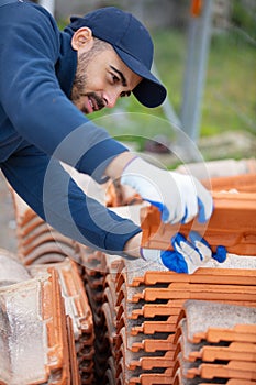 bricklayer working with ceramsite concrete blocks photo
