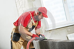 Bricklayer working with ceramsite concrete blocks. Walling