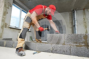 Bricklayer working with ceramsite concrete blocks. Walling photo