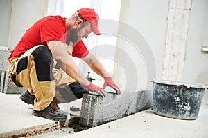 Bricklayer working with ceramsite concrete blocks. Walling photo