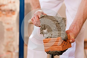 Bricklayer working on construction site