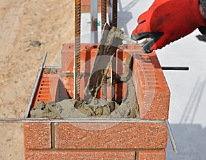 Bricklaying closeup. Bricklayer hand holding a putty knife