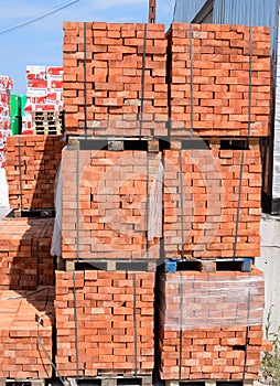 Bricks on pallets. Storage of bricks at construction site