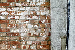 Brickstone And Concrete Wall With Black Waterpipe Detail photo