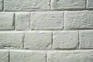 Brickwork covered with white paint. Background from white unequal rectangles