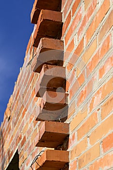 Brickwork wall made of the bricks, construction of a building